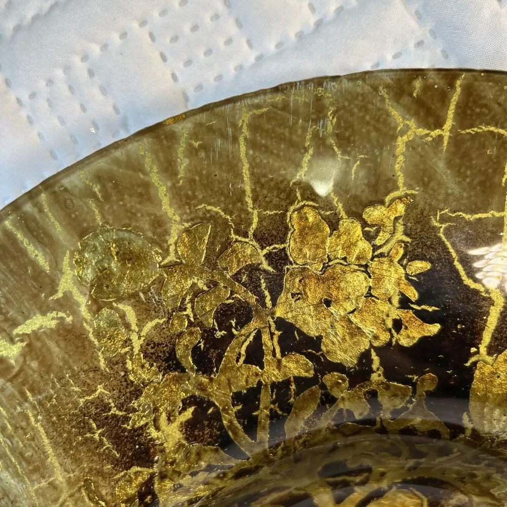 Glass bowl features an asymmetrical shape with a striking black and gold crackle